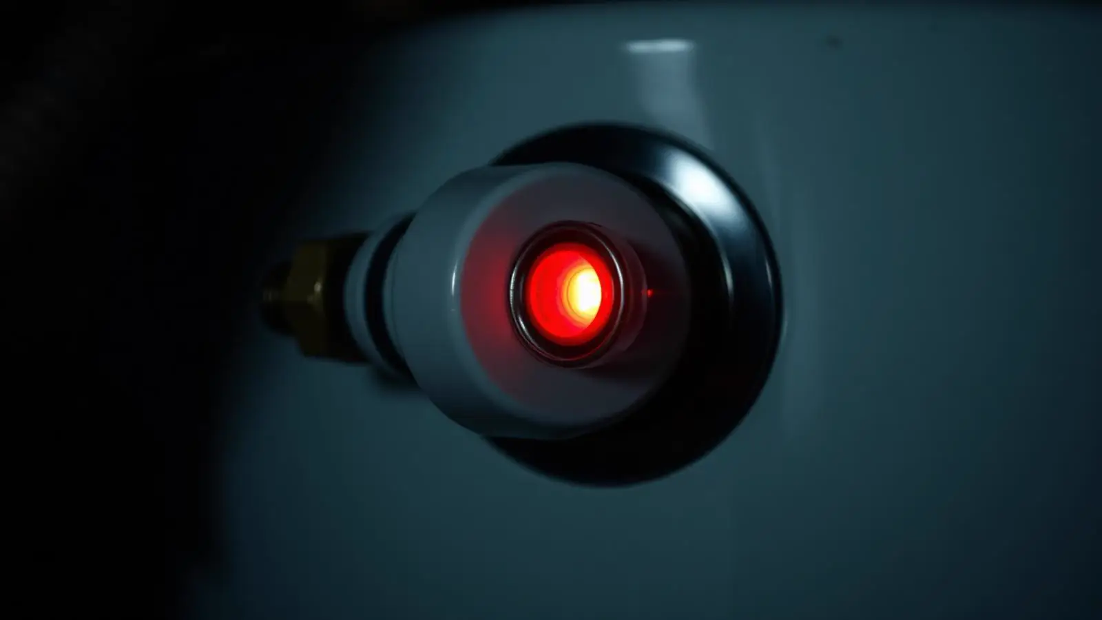 Status indicator light glowing on the gas control valve of a residential water heater