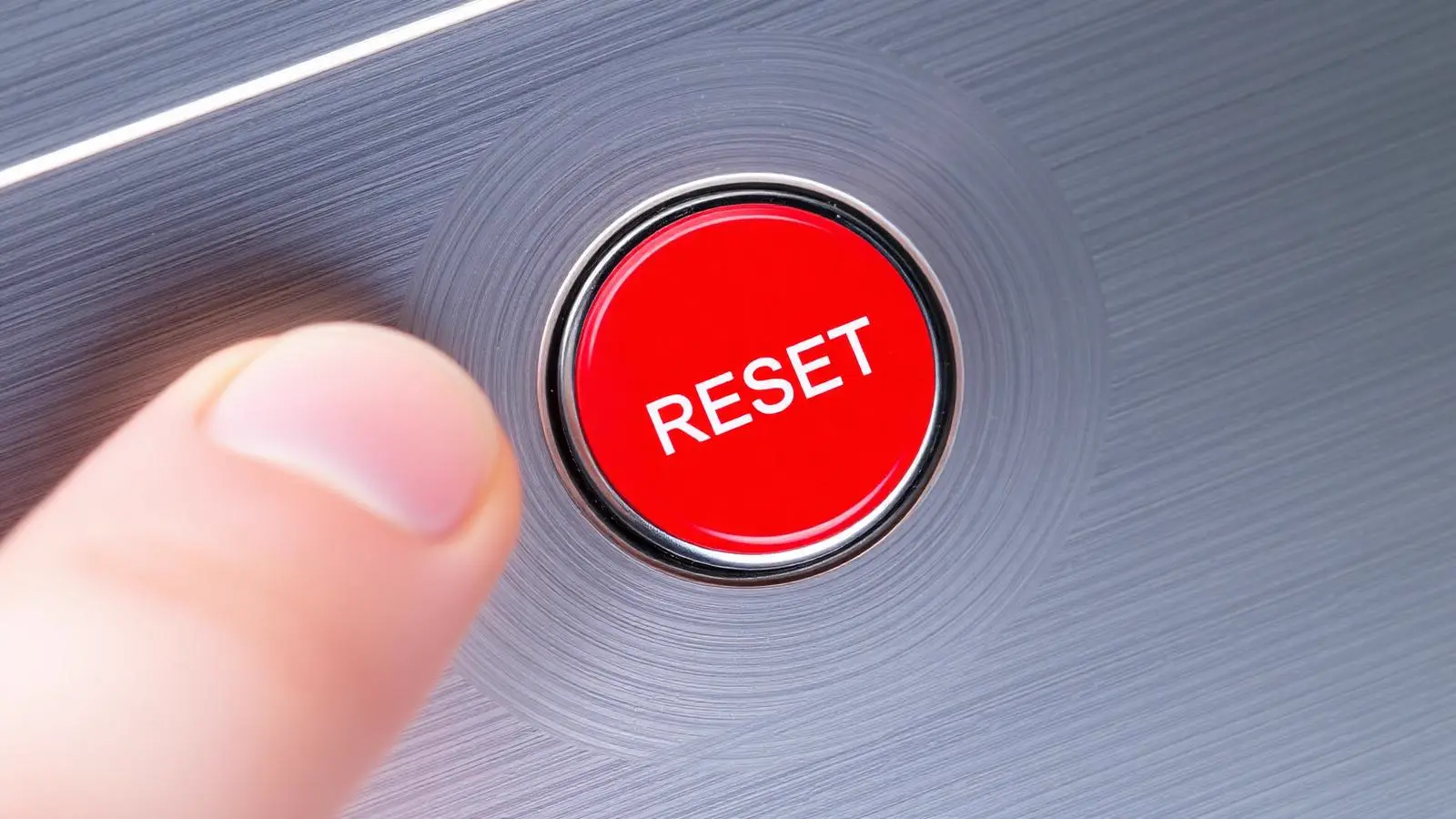Red high-limit reset button behind the upper access panel of an electric water heater
