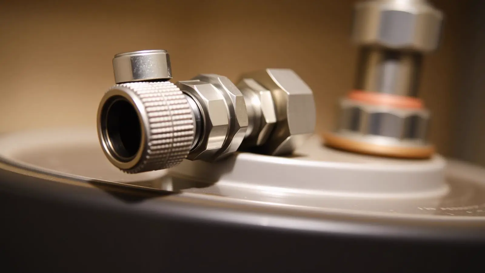 Cold-water inlet shut-off valve and flexible connector at the top of a residential water heater